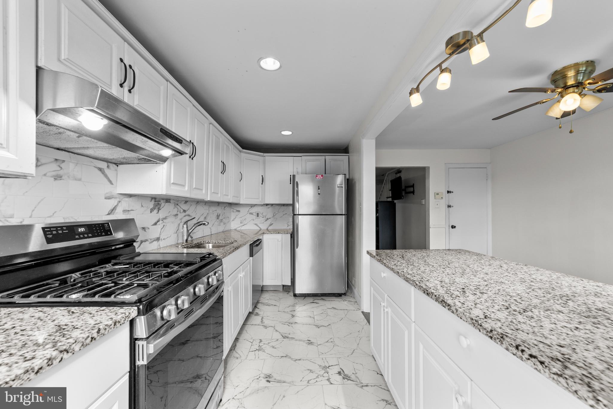 1314 Farrington Road Philadelphia, PA 19151 - Photo 8 of 21 a kitchen with a stove and a refrigerator
