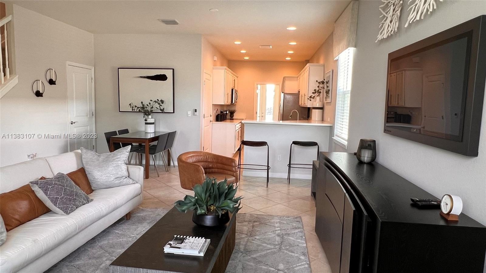 a living room with furniture and a flat screen tv
