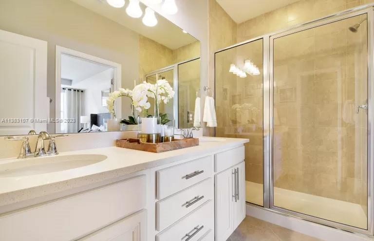 4002 Long Leaf Lane, Unit 6 Hollywood, FL 33021 - Photo 16 of 35 a bathroom with a double vanity sink mirror and shower