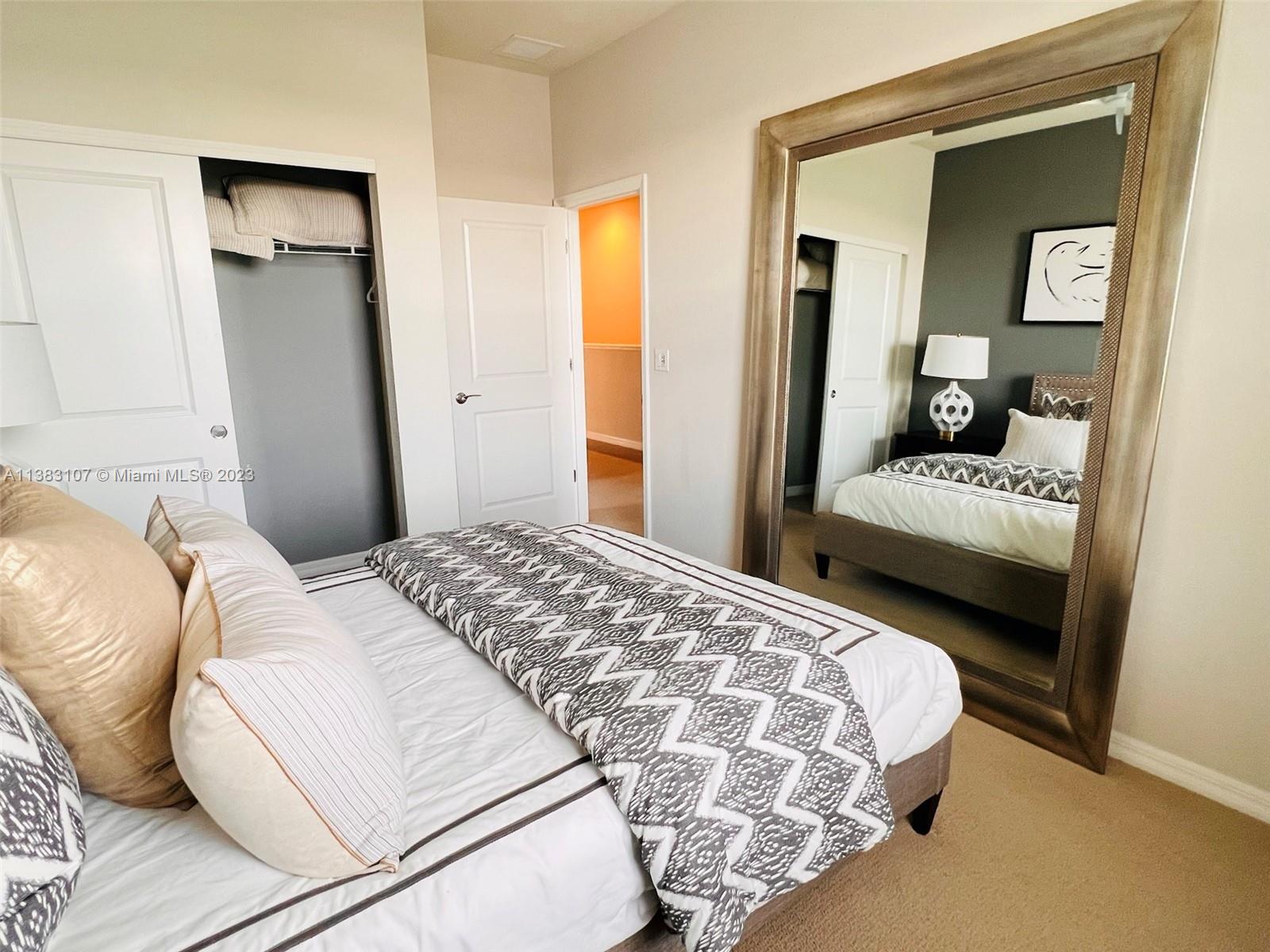 4002 Long Leaf Lane, Unit 6 Hollywood, FL 33021 - Photo 21 of 35 a bedroom with a bed and a mirror