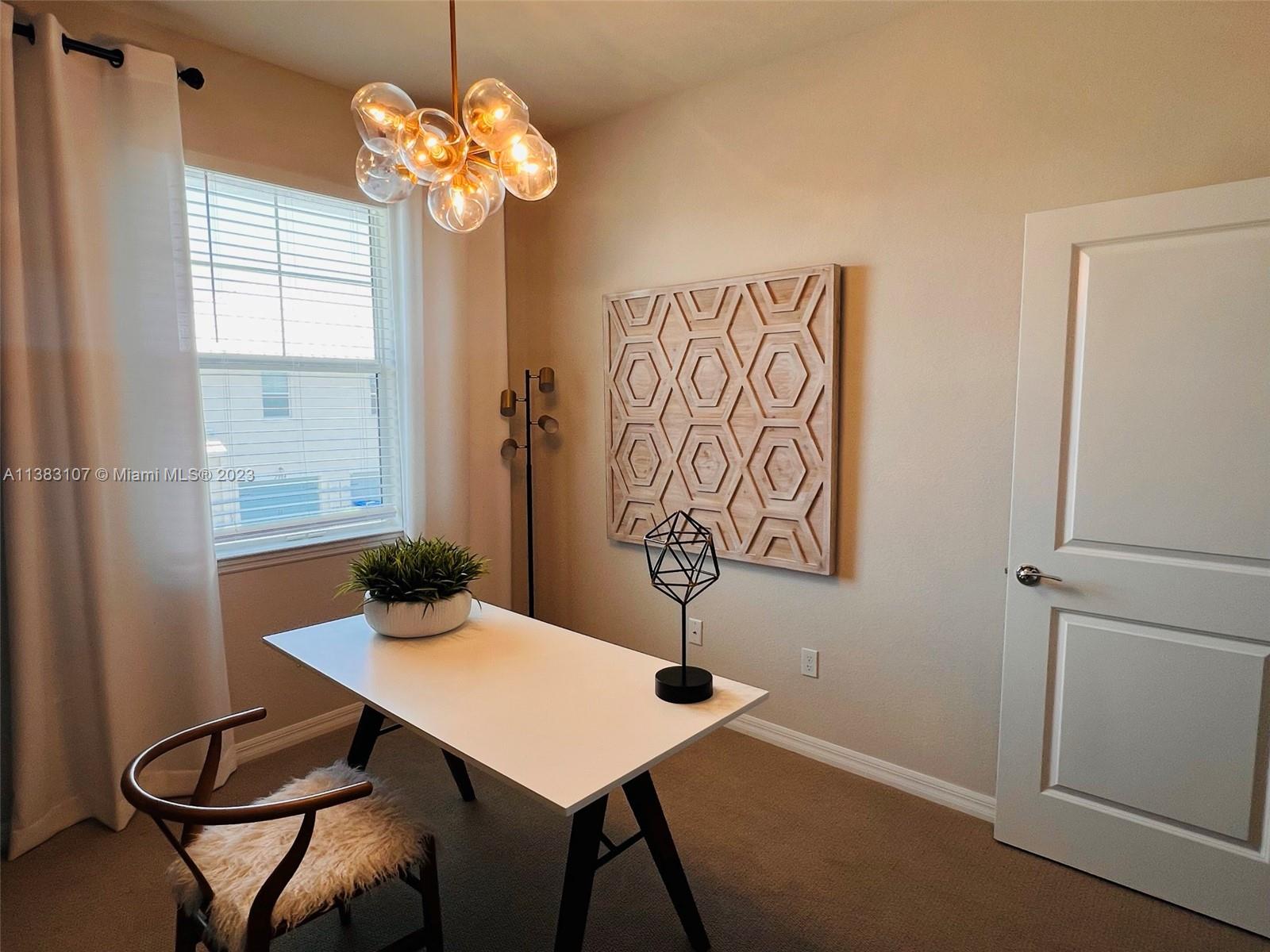 4002 Long Leaf Lane, Unit 6 Hollywood, FL 33021 - Photo 24 of 35 a view of a dining room with furniture and chandelier