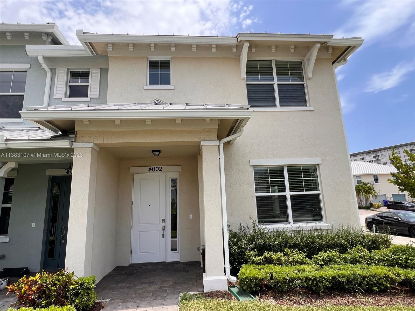 4002 Long Leaf Lane, Unit 6 Hollywood, FL 33021 - Photo 26 of 35 a view of a house with potted plants and a yard