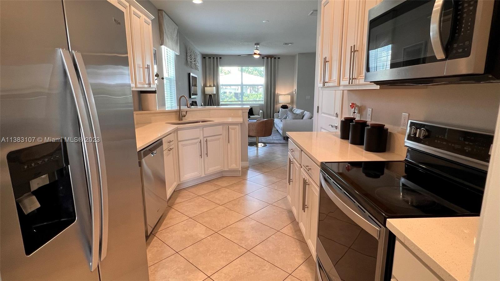 4002 Long Leaf Lane, Unit 6 Hollywood, FL 33021 - Photo 6 of 35 a kitchen with stainless steel appliances granite countertop a refrigerator a stove top oven a sink and dishwasher