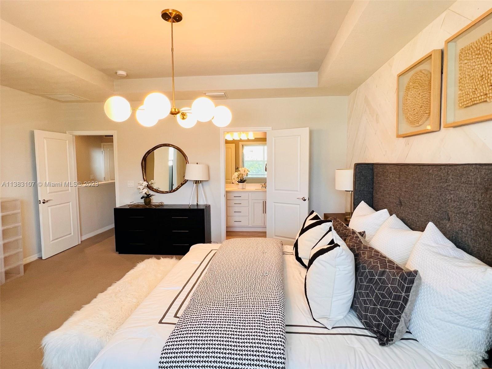 4002 Long Leaf Lane, Unit 6 Hollywood, FL 33021 - Photo 9 of 35 a bedroom with a large bed and a mirror