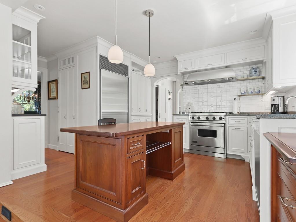 8 Varick Road Newton, MA 02468 - Photo 11 of 42 a kitchen with stainless steel appliances granite countertop a stove and a sink