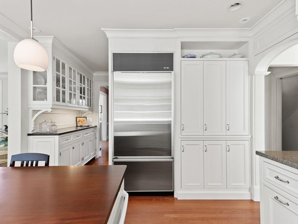 8 Varick Road Newton, MA 02468 - Photo 12 of 42 a kitchen with white cabinets and white appliances