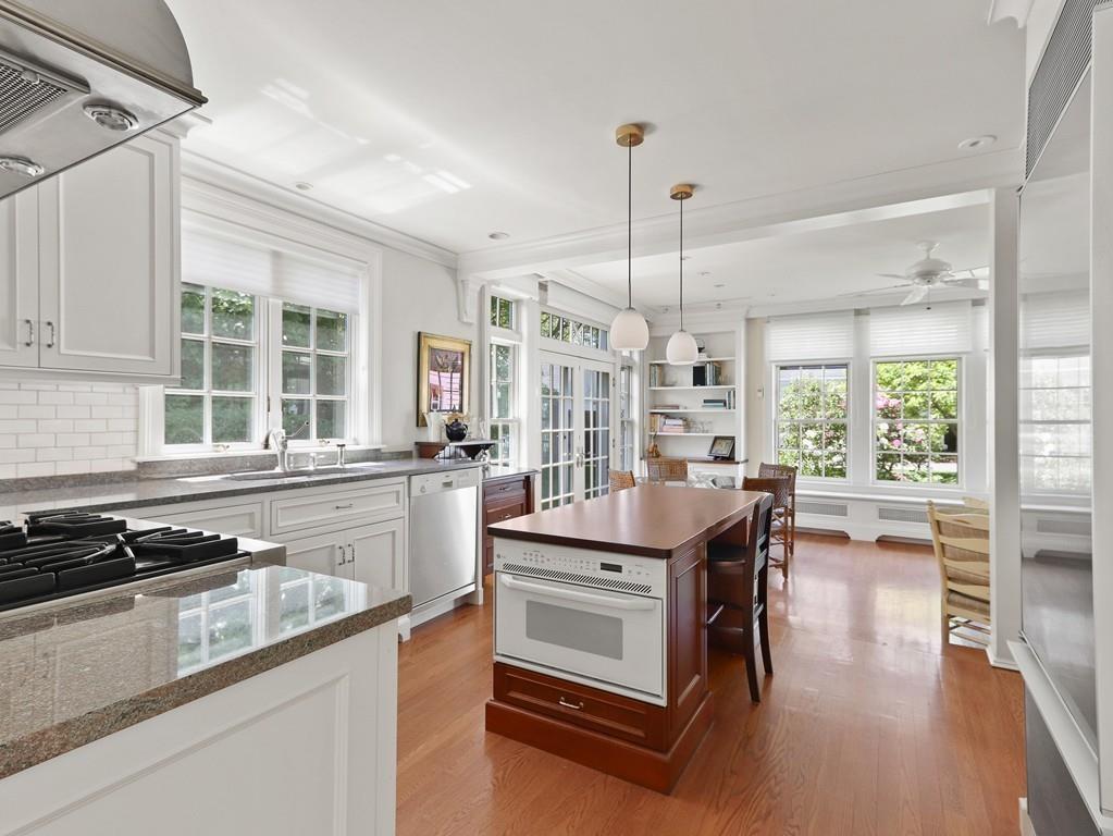 8 Varick Road Newton, MA 02468 - Photo 14 of 42 a kitchen with stainless steel appliances granite countertop a stove and a wooden floors