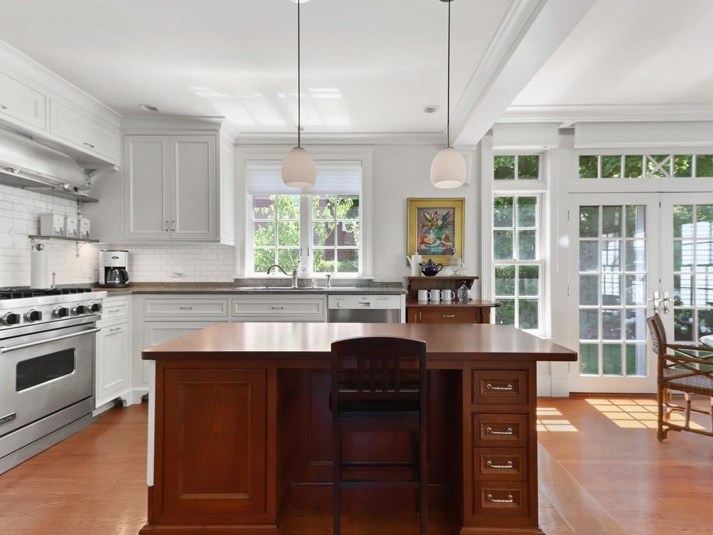 8 Varick Road Newton, MA 02468 - Photo 15 of 42 a kitchen with granite countertop a stove a sink and a refrigerator