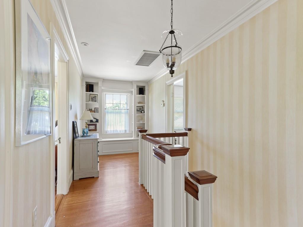 8 Varick Road Newton, MA 02468 - Photo 28 of 42 a view of a hallway with wooden floor and a window
