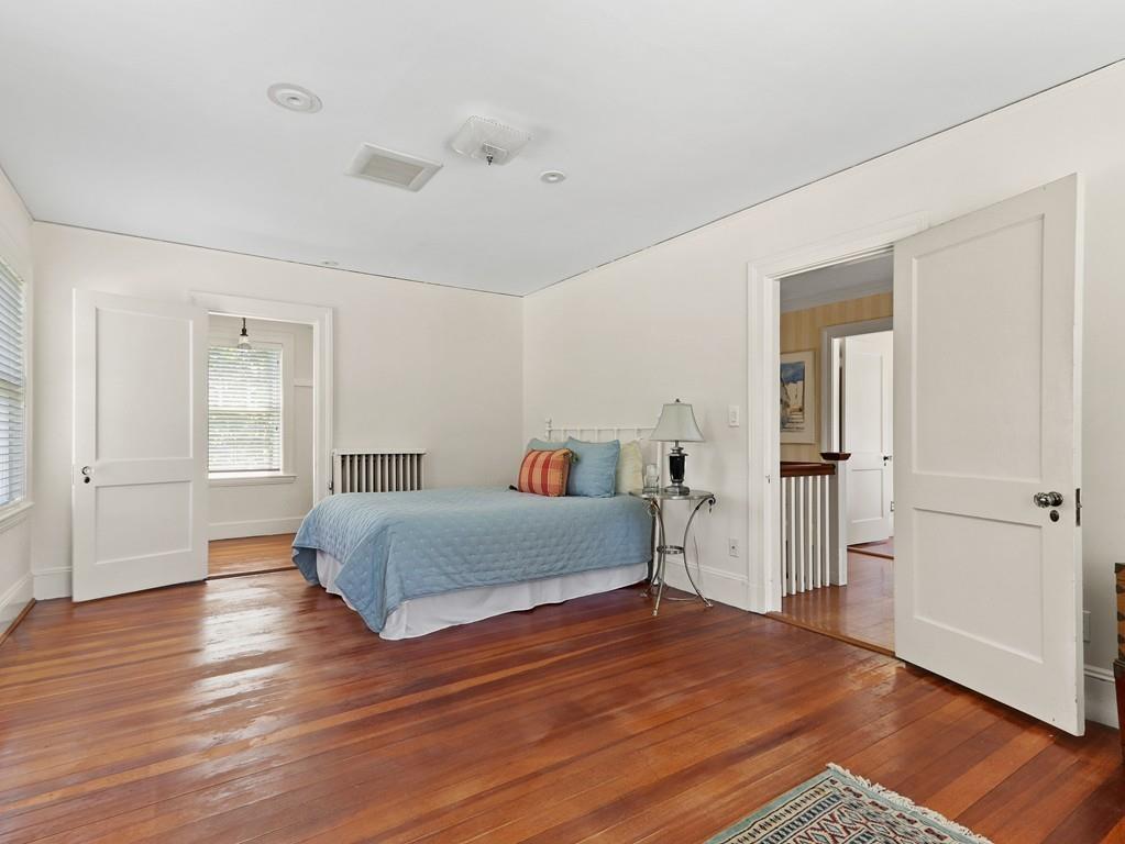 8 Varick Road Newton, MA 02468 - Photo 34 of 42 a living room with a bed and wooden floor