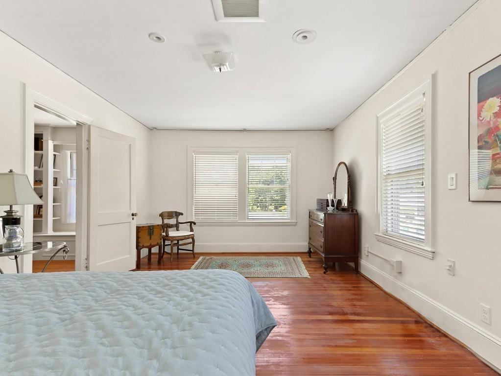 8 Varick Road Newton, MA 02468 - Photo 35 of 42 a spacious bedroom with a bed and a dresser next to a window