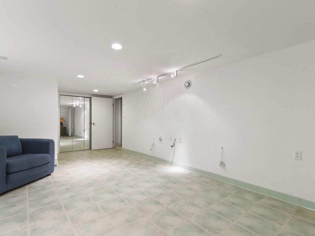 8 Varick Road Newton, MA 02468 - Photo 39 of 42 a view of an empty room with a ceiling fan