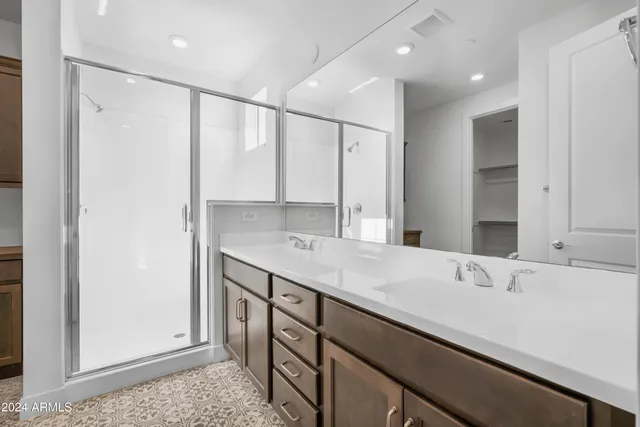 a bathroom with a double vanity sink and a mirror