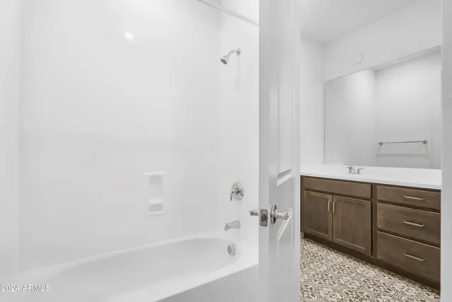 a bathroom with a bathtub and a sink