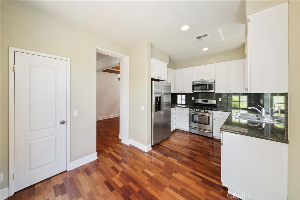 5 Second Street Ladera Ranch, CA 92694 - Photo 13 of 36 a kitchen with stainless steel appliances granite countertop a refrigerator and a stove top oven