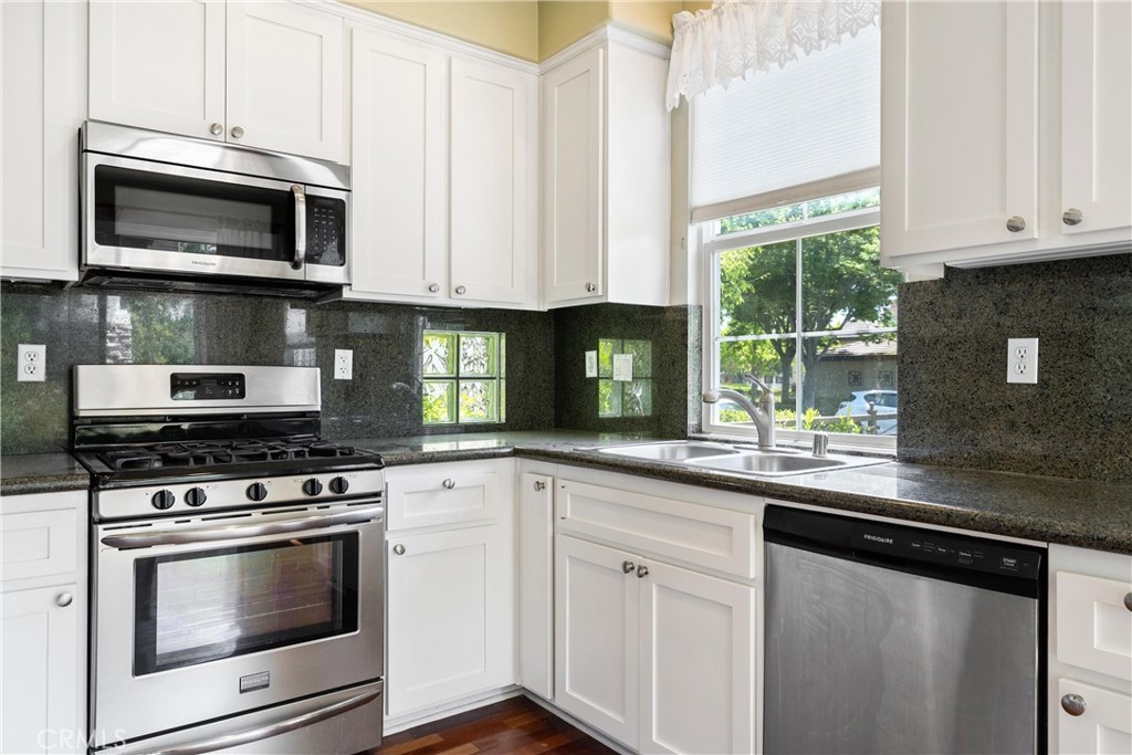 5 Second Street Ladera Ranch, CA 92694 - Photo 15 of 36 a kitchen with white cabinets and appliances