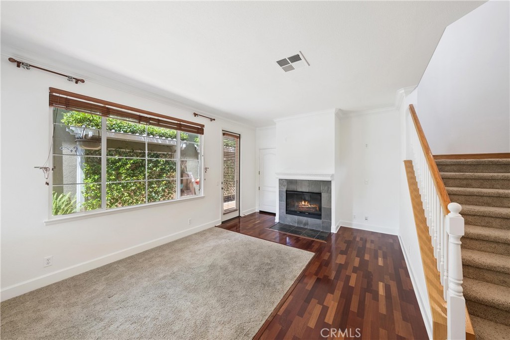 5 Second Street Ladera Ranch, CA 92694 - Photo 16 of 36 a view of a livingroom with wooden floor and a fireplace