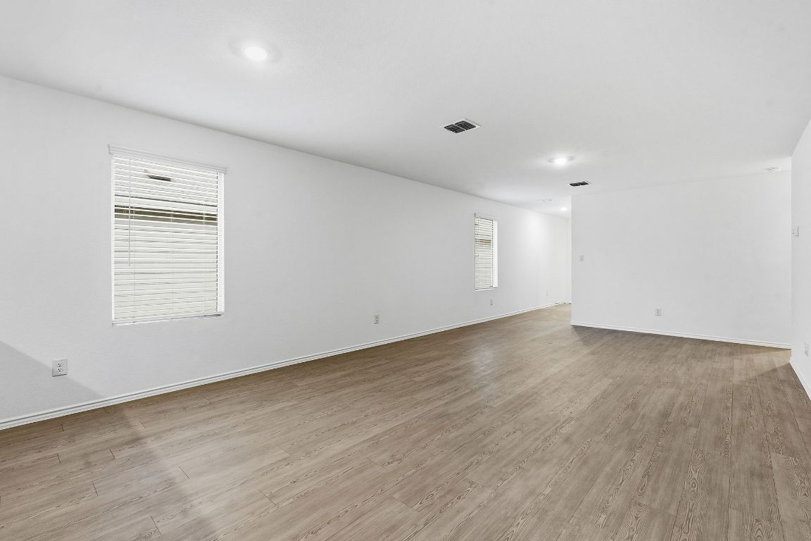 511 Paris Street Maxwell, TX 78656 - Photo 11 of 27 an empty room with wooden floor and windows