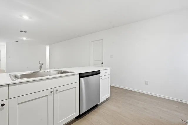 a utility room with sink dryer and washer