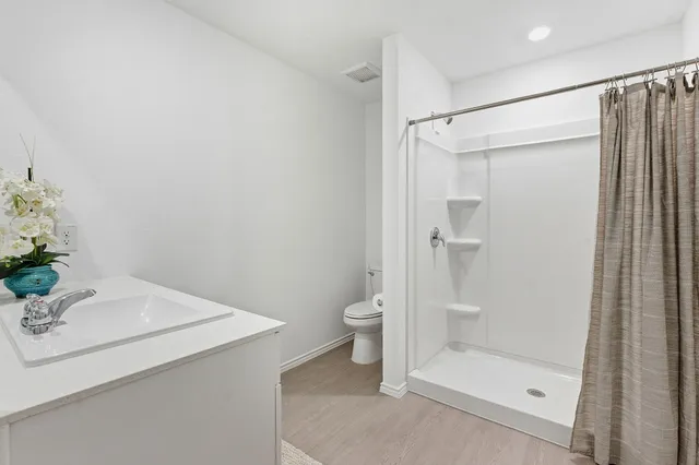a bathroom with a shower and a sink