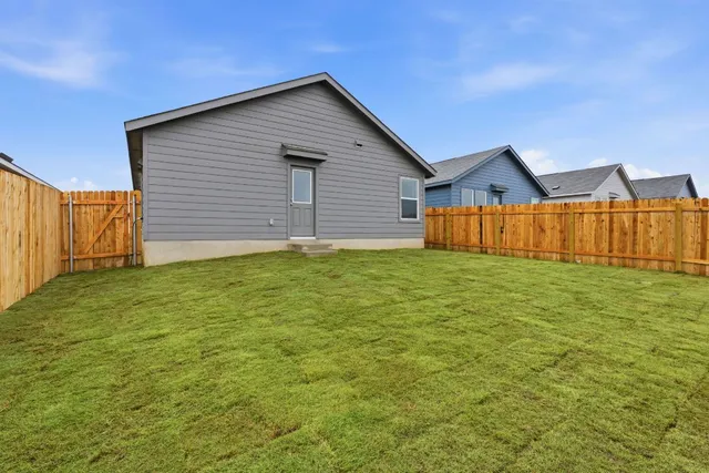 a view of a backyard of the house