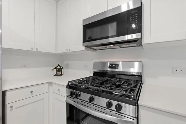 a kitchen with a stove and a microwave