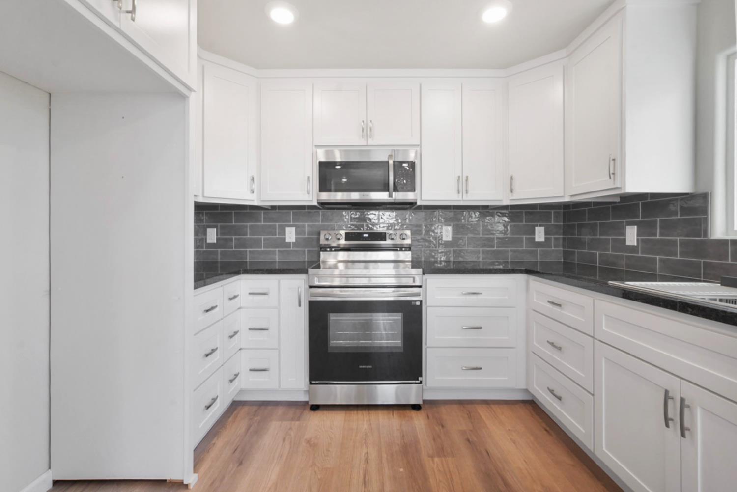 2324 Quail Hill Road Copperopolis, CA 95228 - Photo 13 of 37 a kitchen with stainless steel appliances granite countertop a stove a sink and a microwave