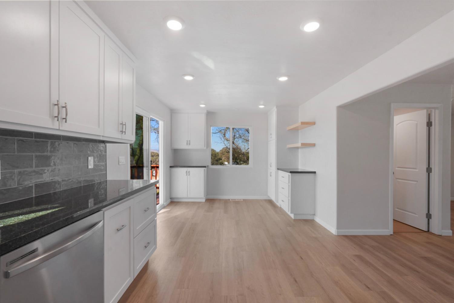 2324 Quail Hill Road Copperopolis, CA 95228 - Photo 14 of 37 a large kitchen with cabinets and wooden floor