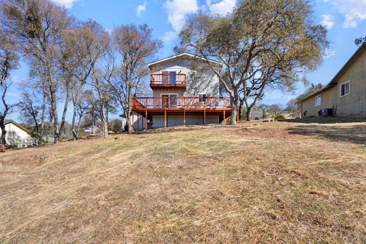 2324 Quail Hill Road Copperopolis, CA 95228 - Photo 24 of 37 a view of a house with a yard covered with snow in front of house