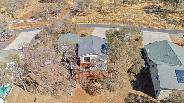 aerial view of a house with a yard