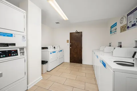 a kitchen with a refrigerator a stove top oven and a cabinets