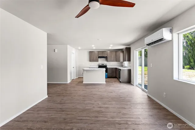 a view of a kitchen with a sink and an empty room