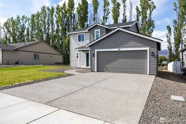 a front view of a house with a yard and garage