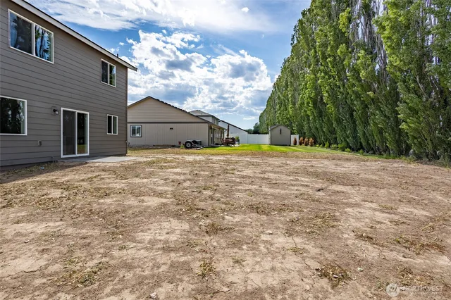 a backyard of a house with large trees