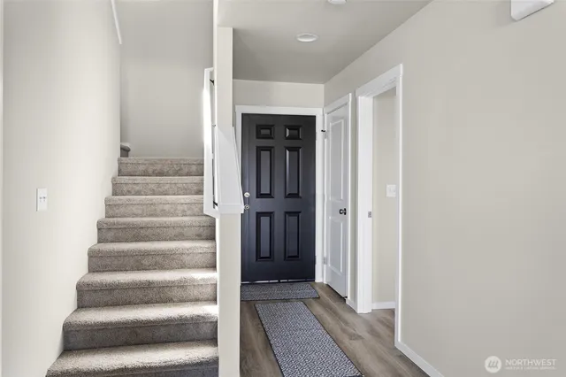 a view of an entryway with wooden floor