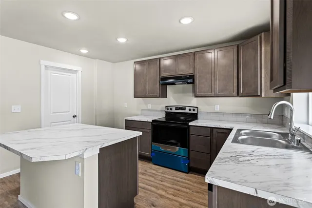 a kitchen with a stove and a sink