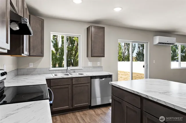 a kitchen with a sink cabinets and window
