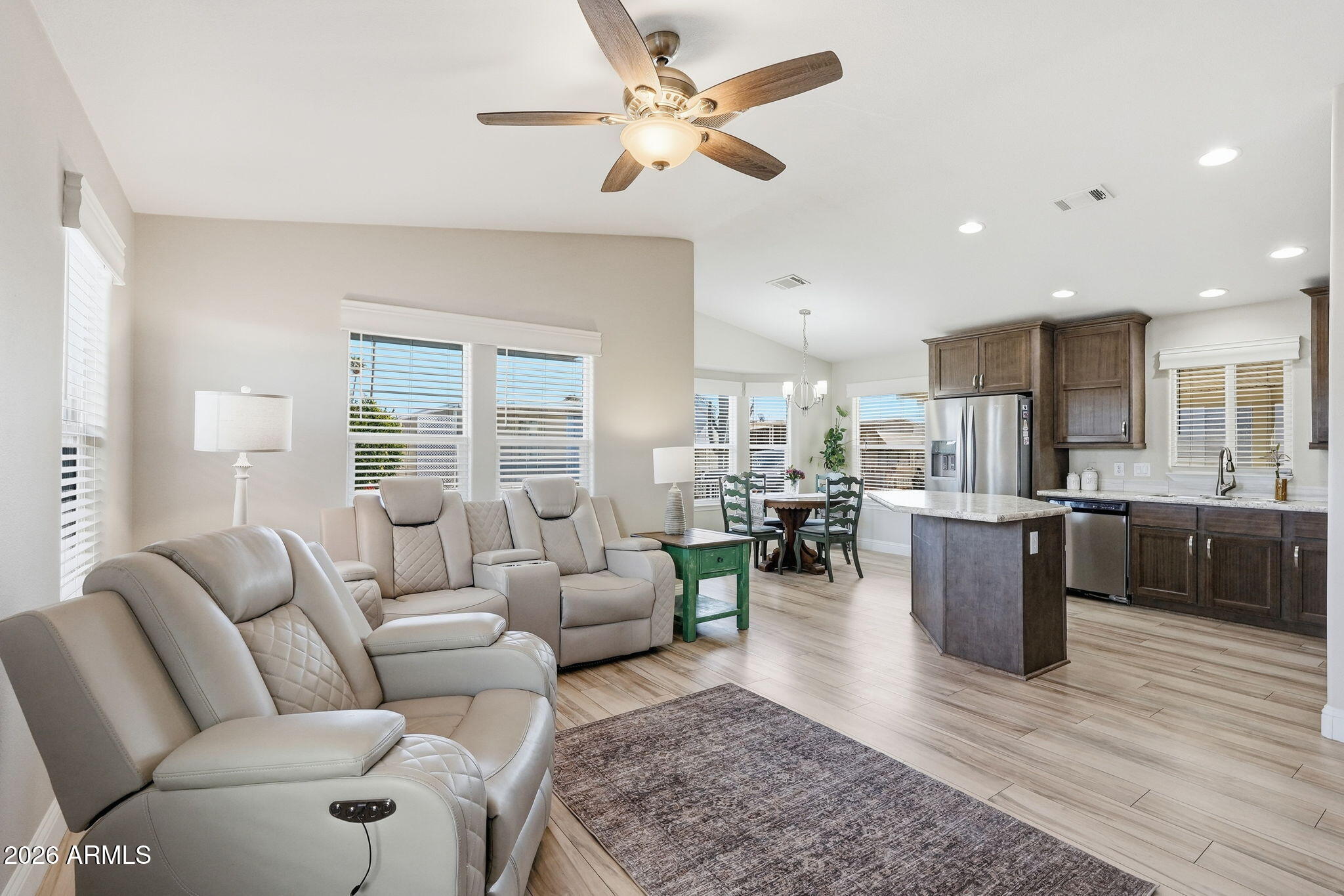 8865 East Baseline Road, Unit 1417 Mesa, AZ 85209 - Photo 9 of 47 a living room with furniture kitchen area and a wooden floor