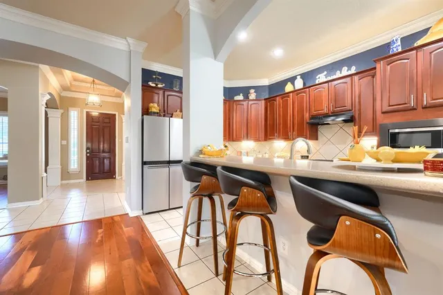 a kitchen with stainless steel appliances granite countertop a sink and cabinets