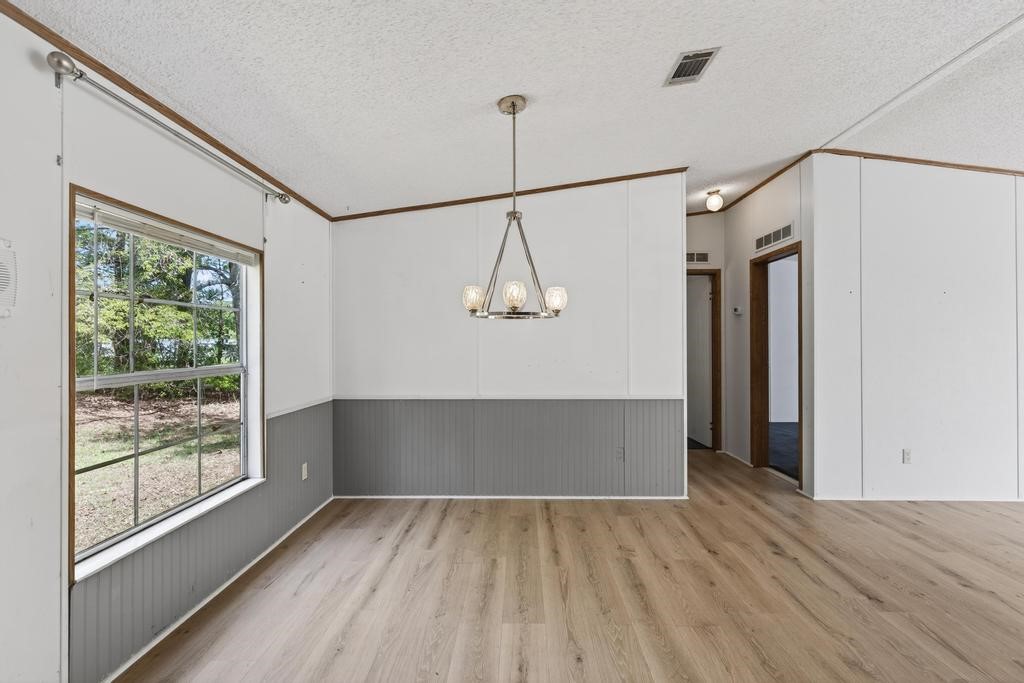 54059 Charles Street Callahan, FL 32011 - Photo 13 of 50 a view of a room with wooden floor and windows