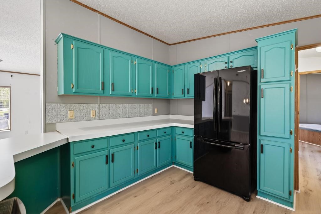 54059 Charles Street Callahan, FL 32011 - Photo 19 of 50 a kitchen with stainless steel appliances granite countertop a refrigerator and a sink