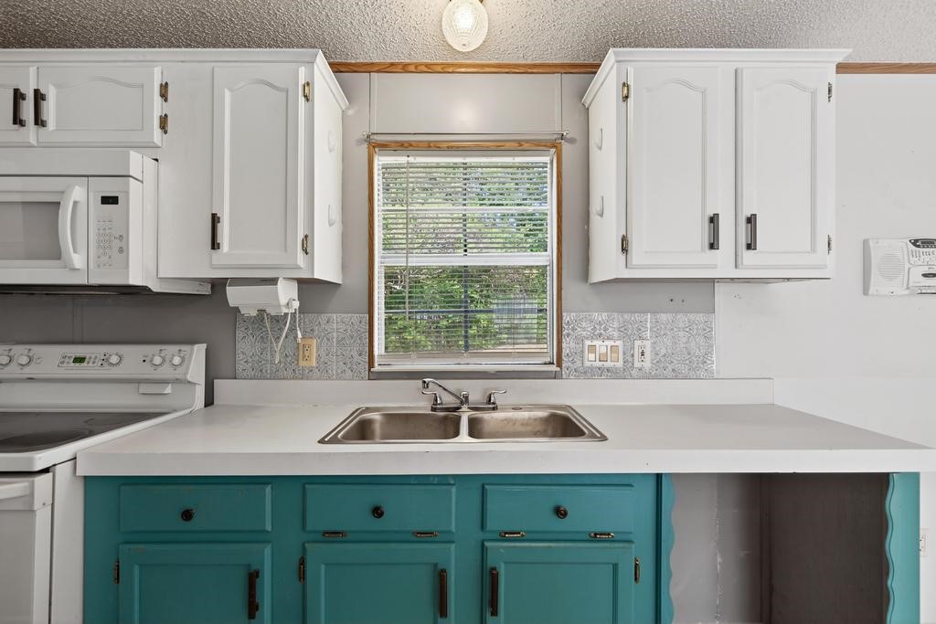54059 Charles Street Callahan, FL 32011 - Photo 20 of 50 a kitchen with stainless steel appliances granite countertop a sink and a white cabinets