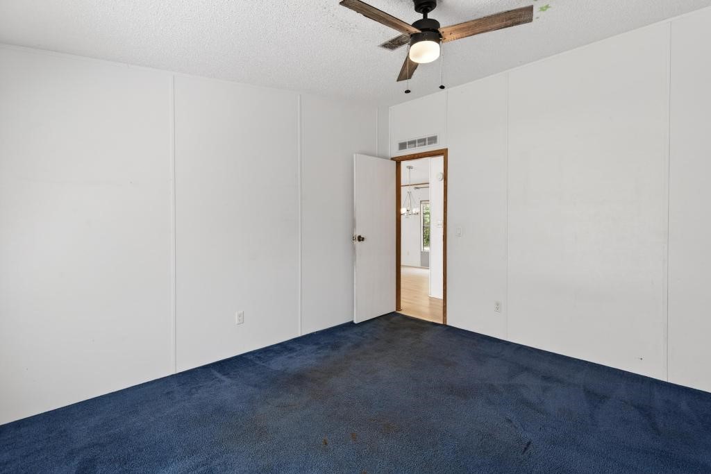 54059 Charles Street Callahan, FL 32011 - Photo 24 of 50 an empty room with a ceiling fan and carpet