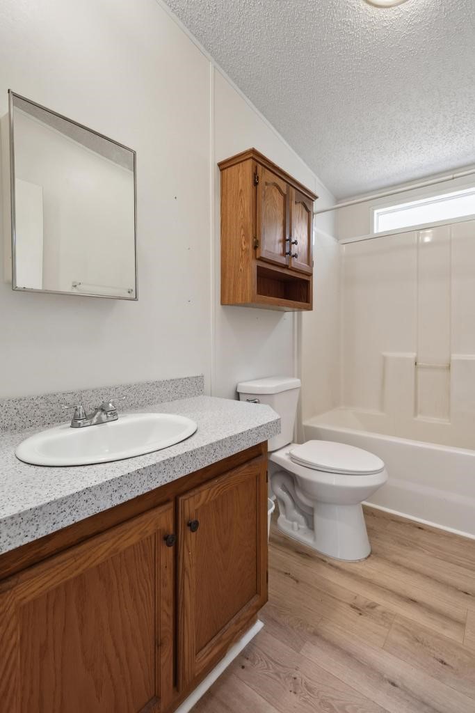 54059 Charles Street Callahan, FL 32011 - Photo 26 of 50 a bathroom with a granite countertop toilet sink and mirror