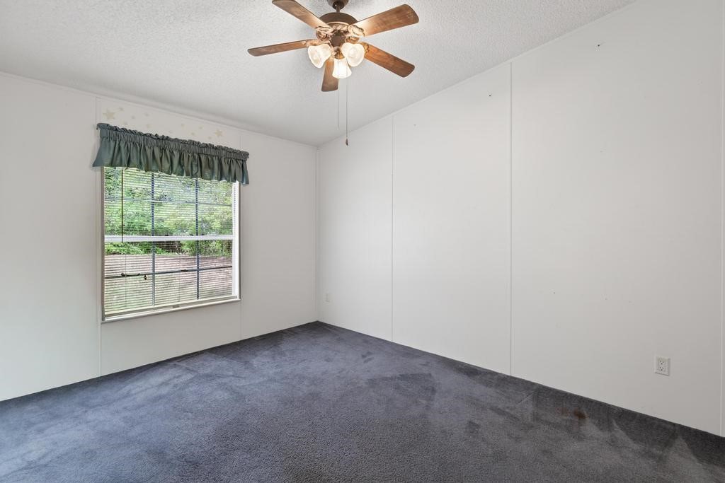54059 Charles Street Callahan, FL 32011 - Photo 28 of 50 an empty room with a window and a fan