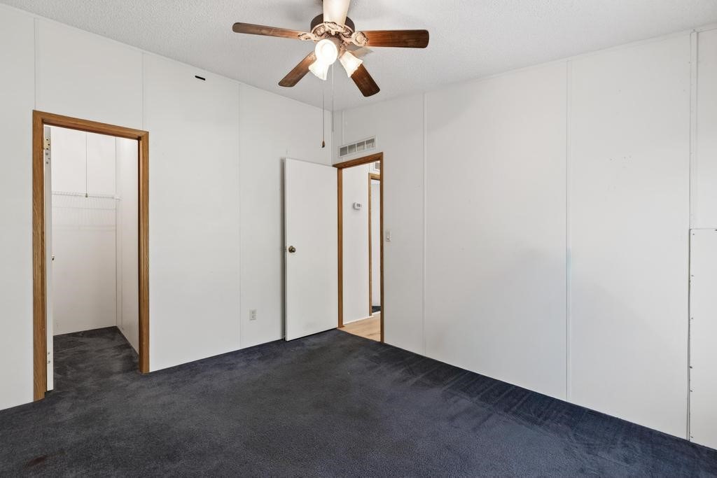 54059 Charles Street Callahan, FL 32011 - Photo 29 of 50 an empty room with closet and a chandelier fan