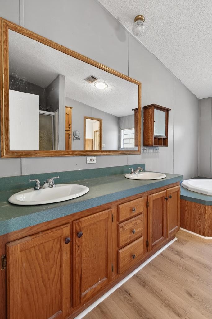 54059 Charles Street Callahan, FL 32011 - Photo 33 of 50 a bathroom with a sink double vanity granite and a mirror
