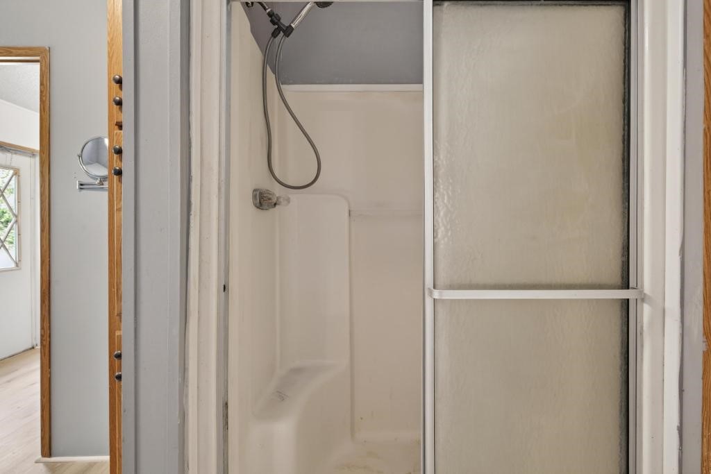 54059 Charles Street Callahan, FL 32011 - Photo 34 of 50 a bathroom with a glass shower door