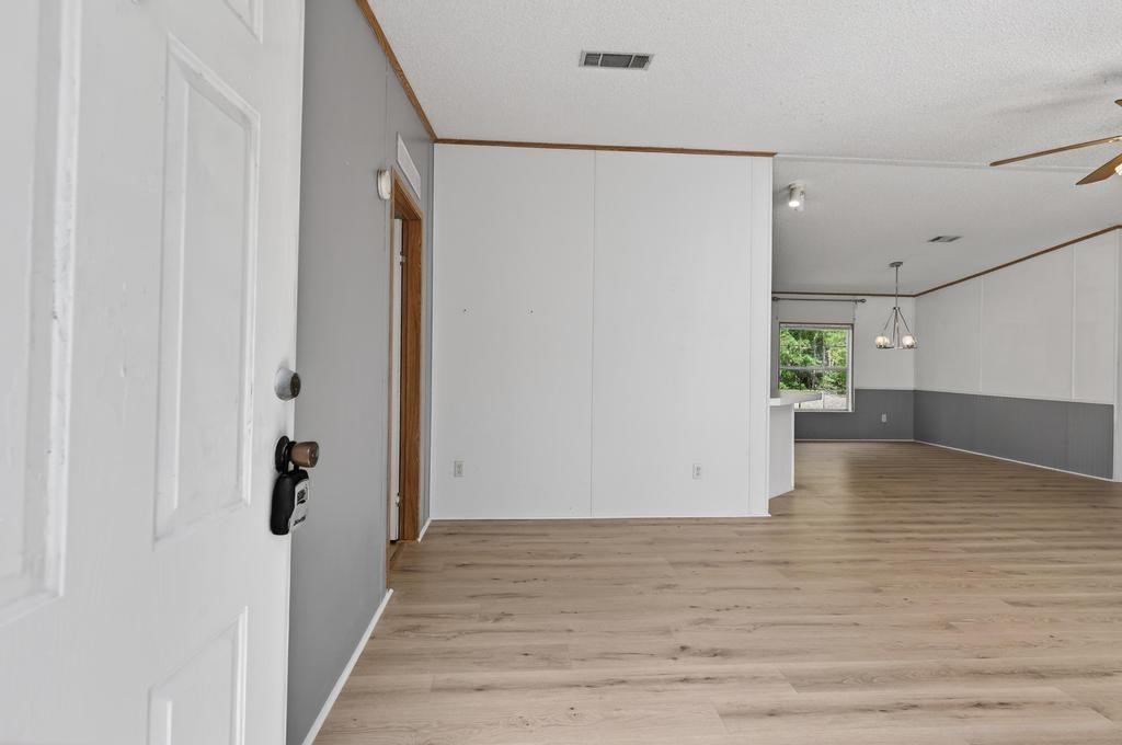 54059 Charles Street Callahan, FL 32011 - Photo 5 of 50 a view of empty room with wooden floor