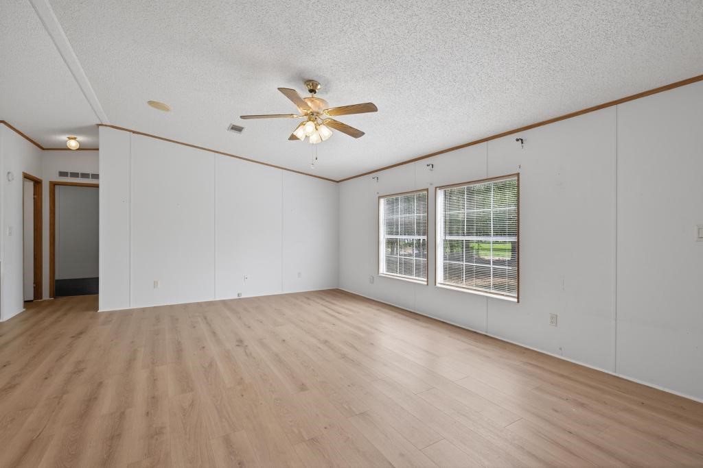54059 Charles Street Callahan, FL 32011 - Photo 8 of 50 a view of empty room with wooden floor and fan